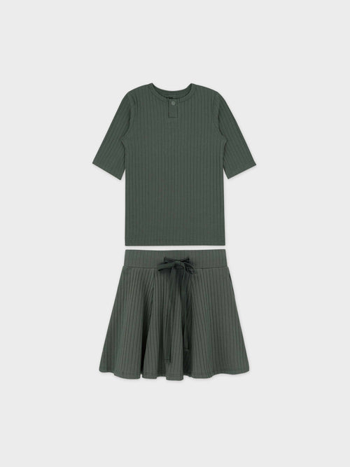 Green ribbed two-piece set: short-sleeve Henley shirt with snap buttons and matching skirt with tie belt.