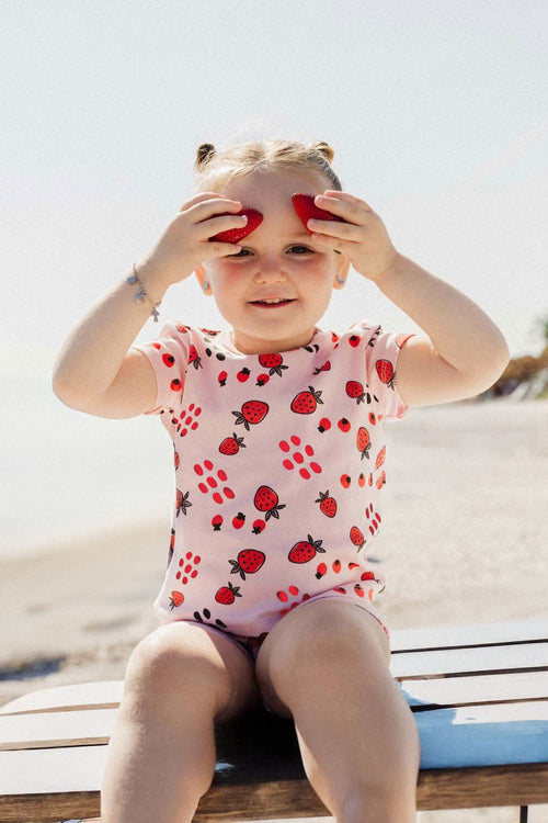 Girl in strawberry print outfit