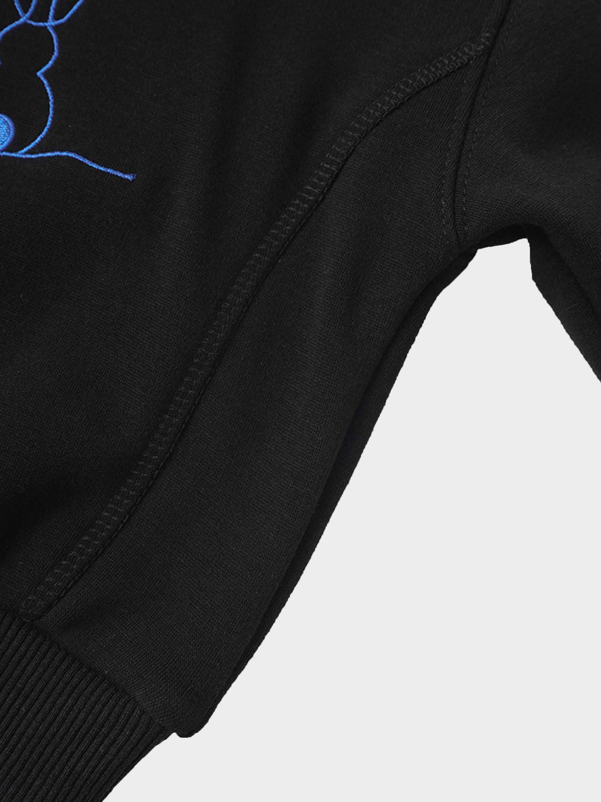 Blue bunny embroidery on black sweatshirt sleeve.
