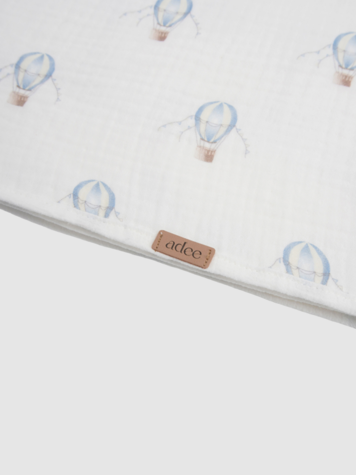 Blue balloon swaddle blanket for boys by Adee, white fabric with light blue balloon motifs