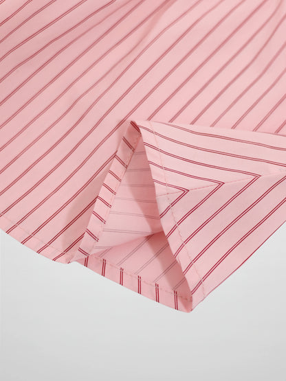 Pink striped cotton skirt with red lines, fabric folded at hem.