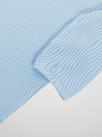 Close-up of light blue pinstripe 3/4 puff sleeve cuff on a T-shirt.