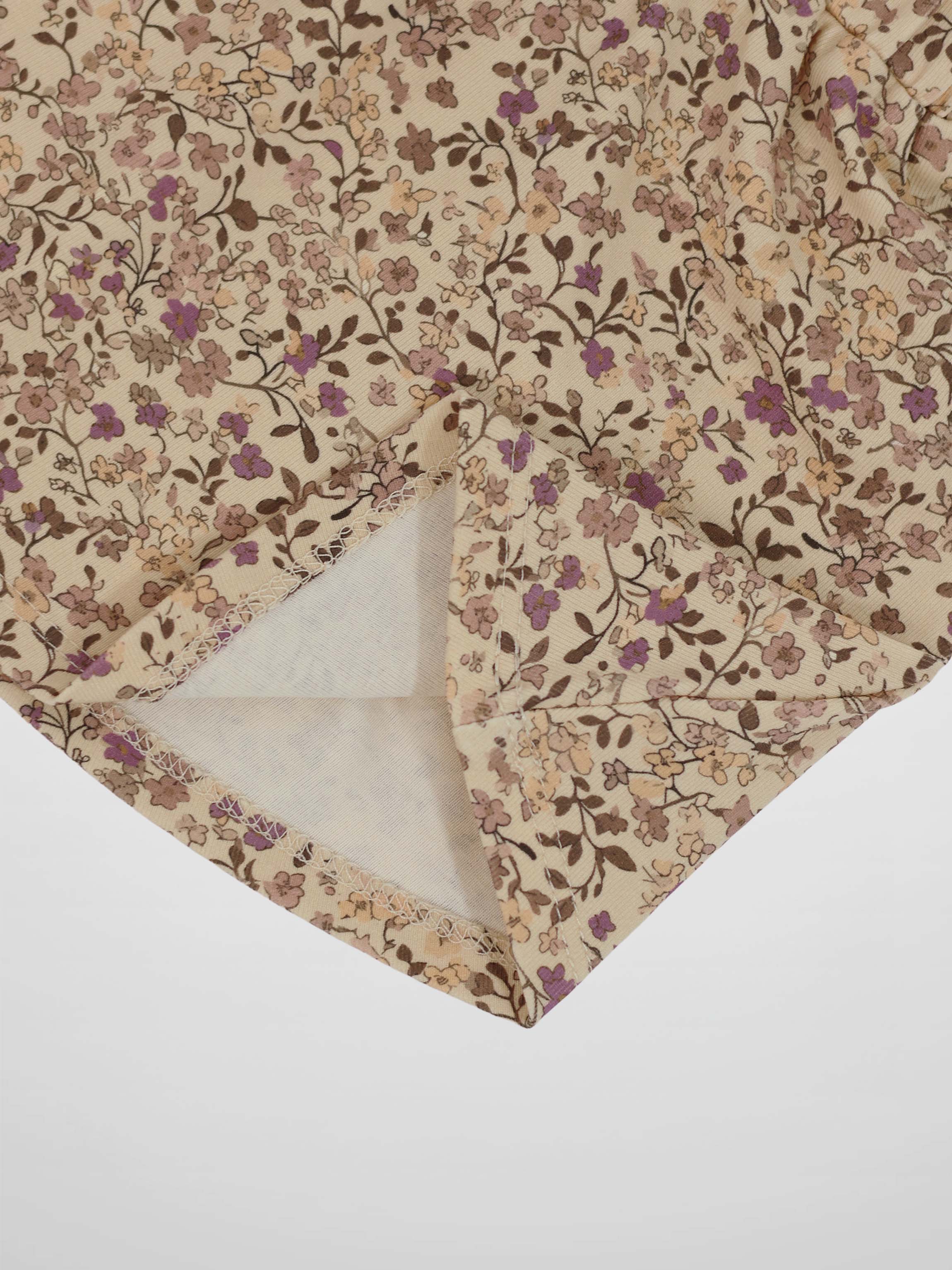 Purple Flower Skirt fabric with beige background and tiny pink, purple, and brown blossoms on branches.
