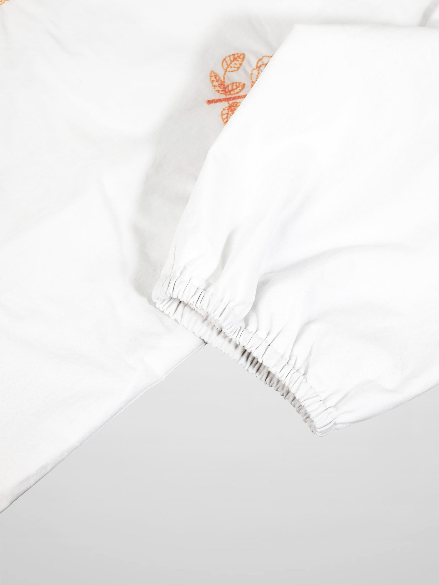 Embroidered Flower Shirt by Adee; white girls dressy T-shirt with orange floral embroidery and elastic cuffs.