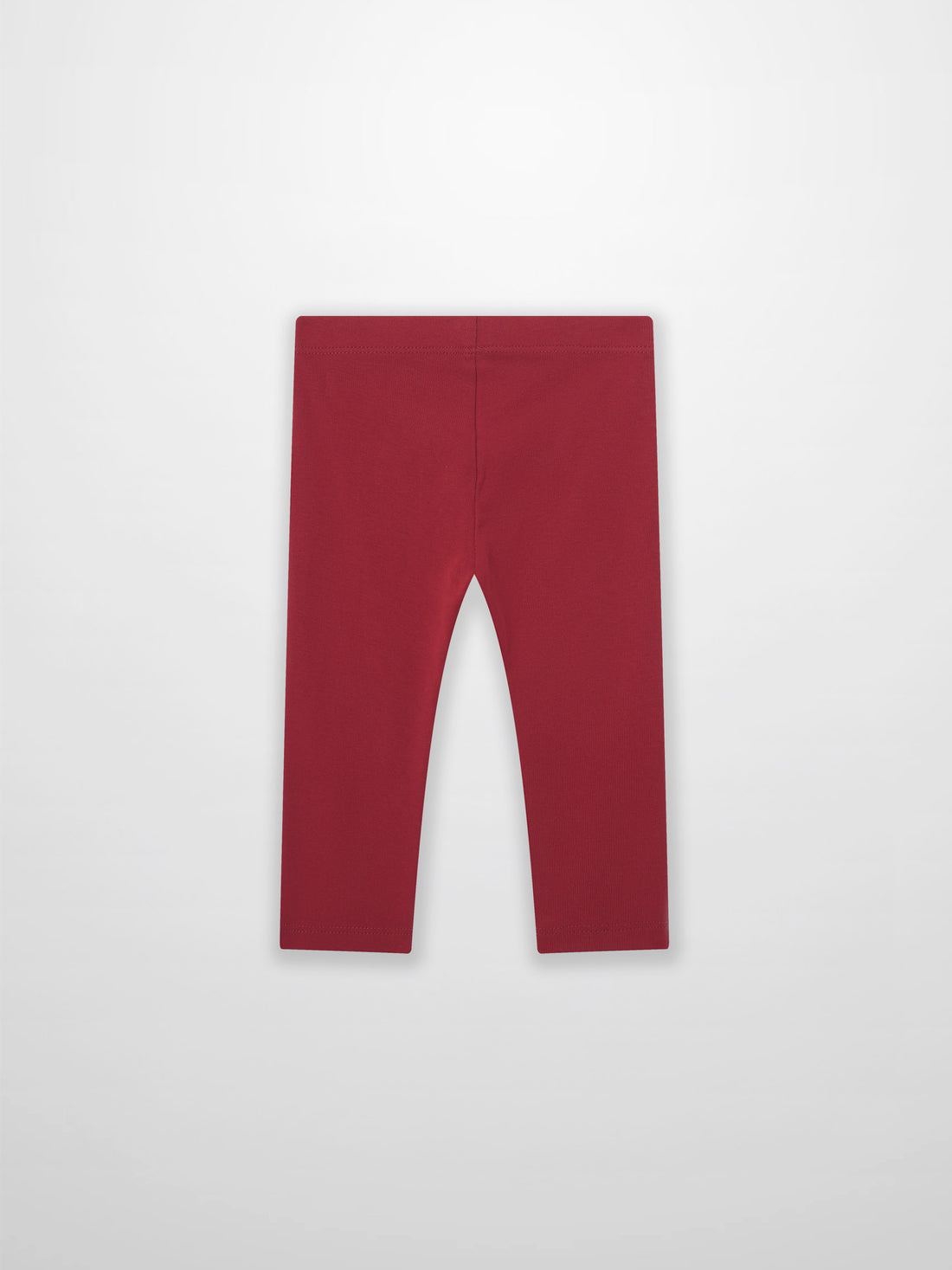 Non ribbed red leggings for unisex bottoms; plain fabric with visible waistband.