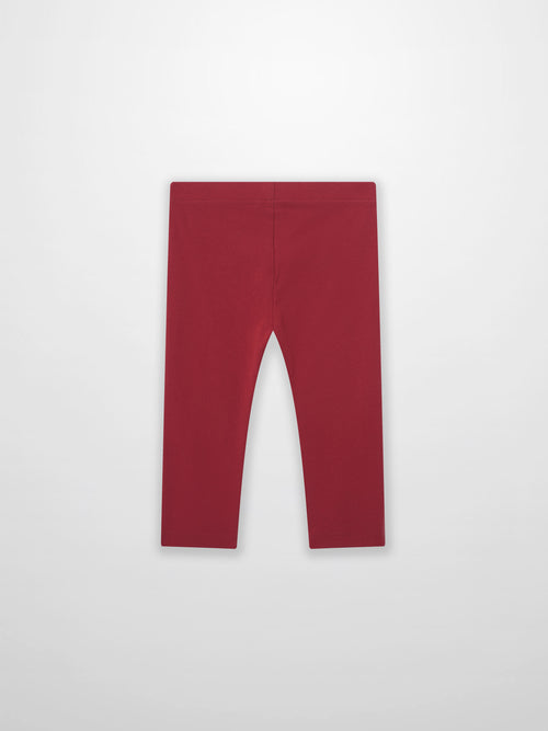 Non ribbed red leggings for unisex bottoms; plain fabric with visible waistband.
