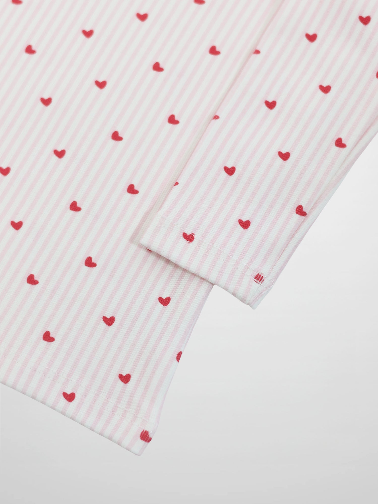 Pink Heart Pajamas for girls; pink striped fabric with red hearts.