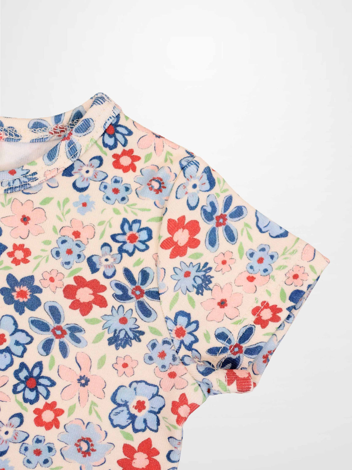 Garden Flower short sleeve shirt for girls by Adee with pink background and blue, red, and pink floral print.