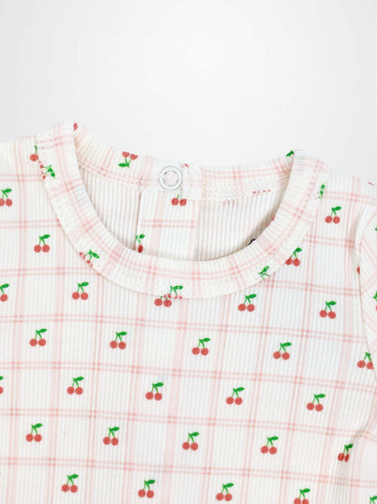 Cherry Window Stretchy girls top featuring tiny red cherries on pale pink plaid knit fabric with round neckline