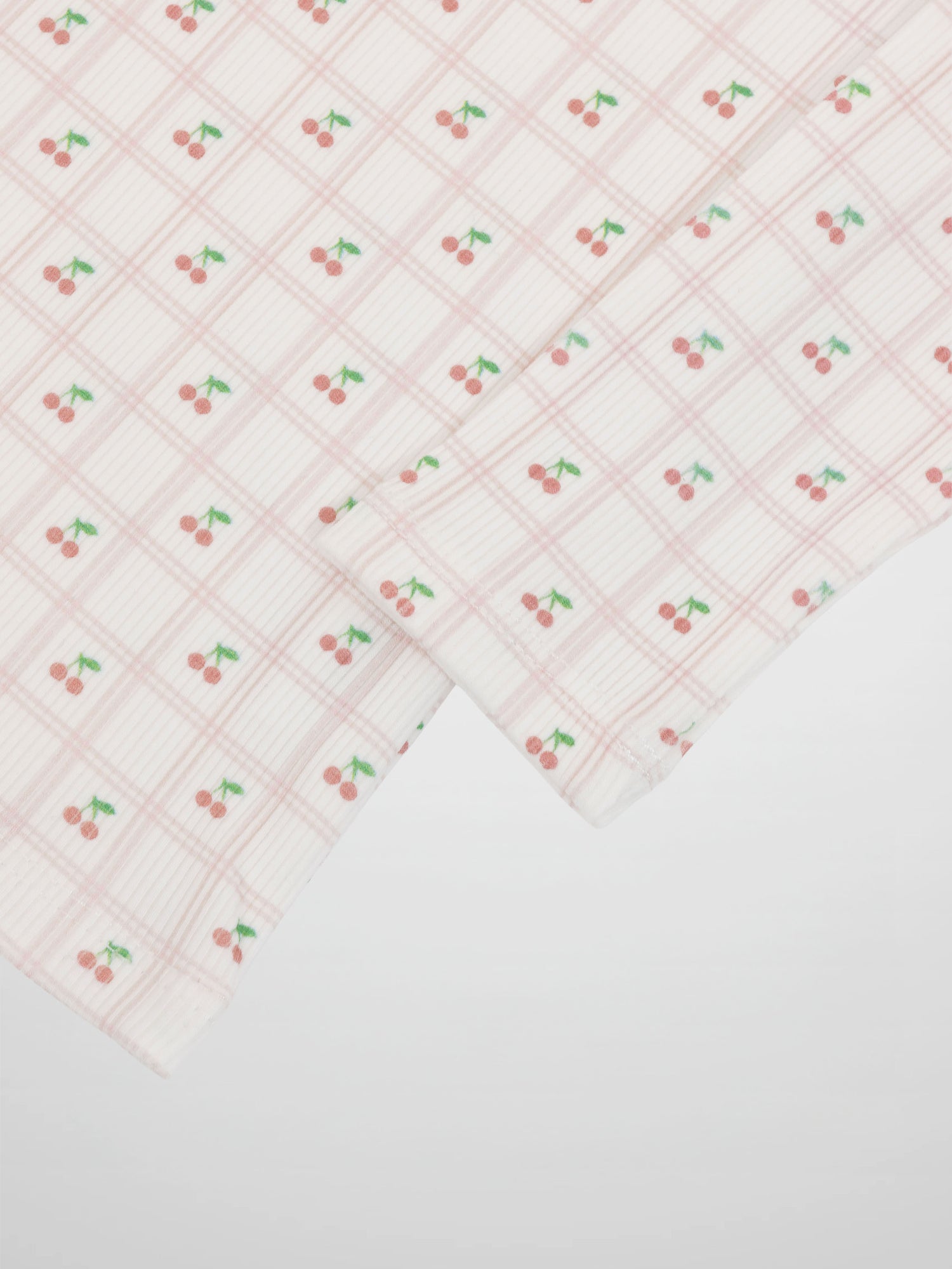 Cherry Window Pajamas for girls by Adee in light pink plaid grid with cherry motifs.