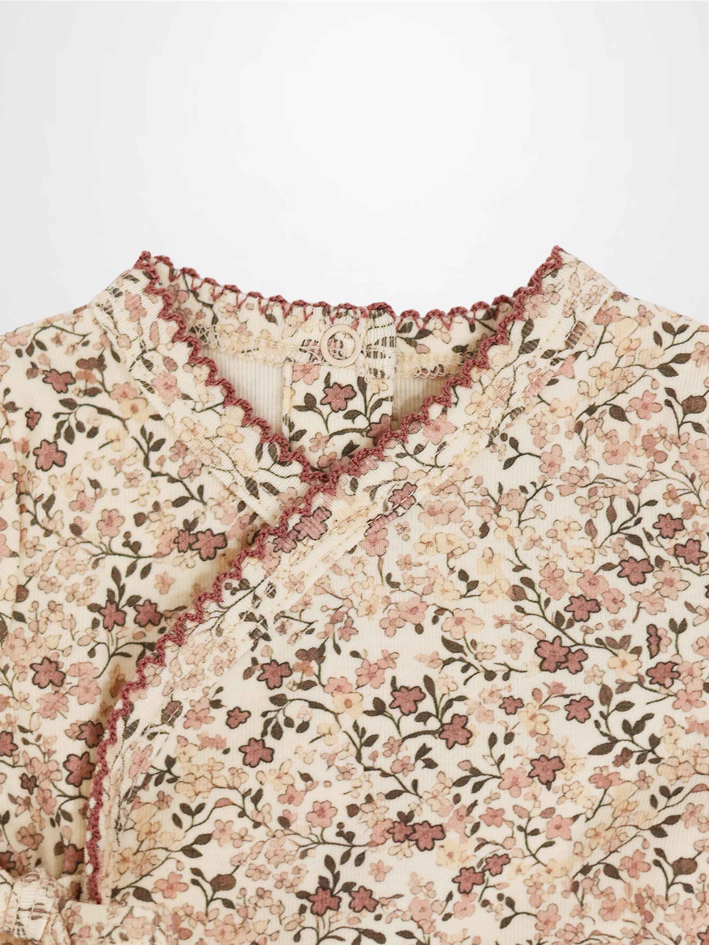 Purple Flower Stretchy girls stretchies with all-over pink floral print on cream background