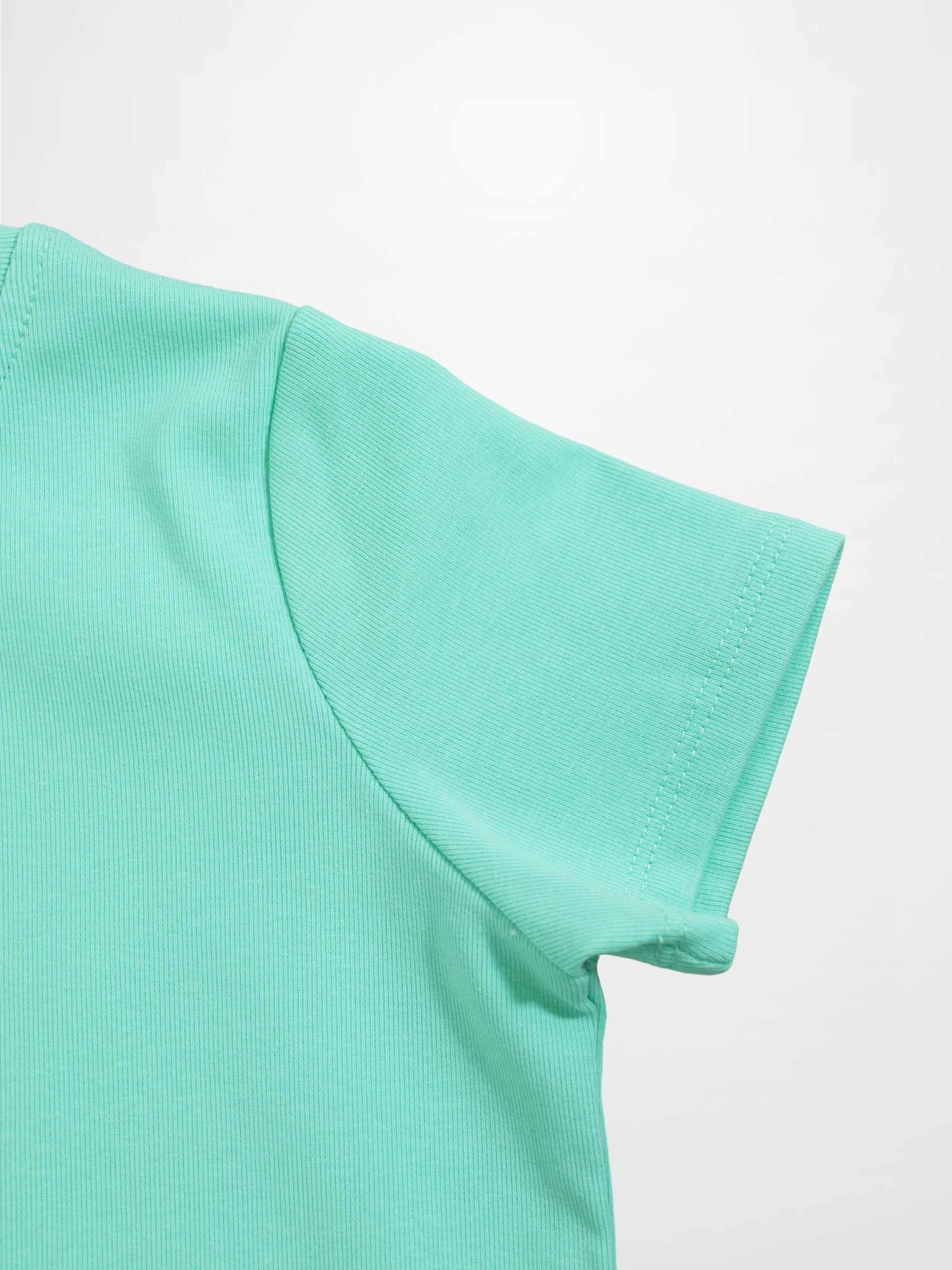 Mint green thin ribbed T-shirt sleeve close-up with visible stitching.
