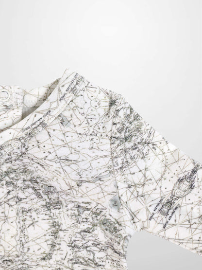 Map Stretchy baby boy jumpsuit footie with off-white fabric and sage-green map lines and compass markers.