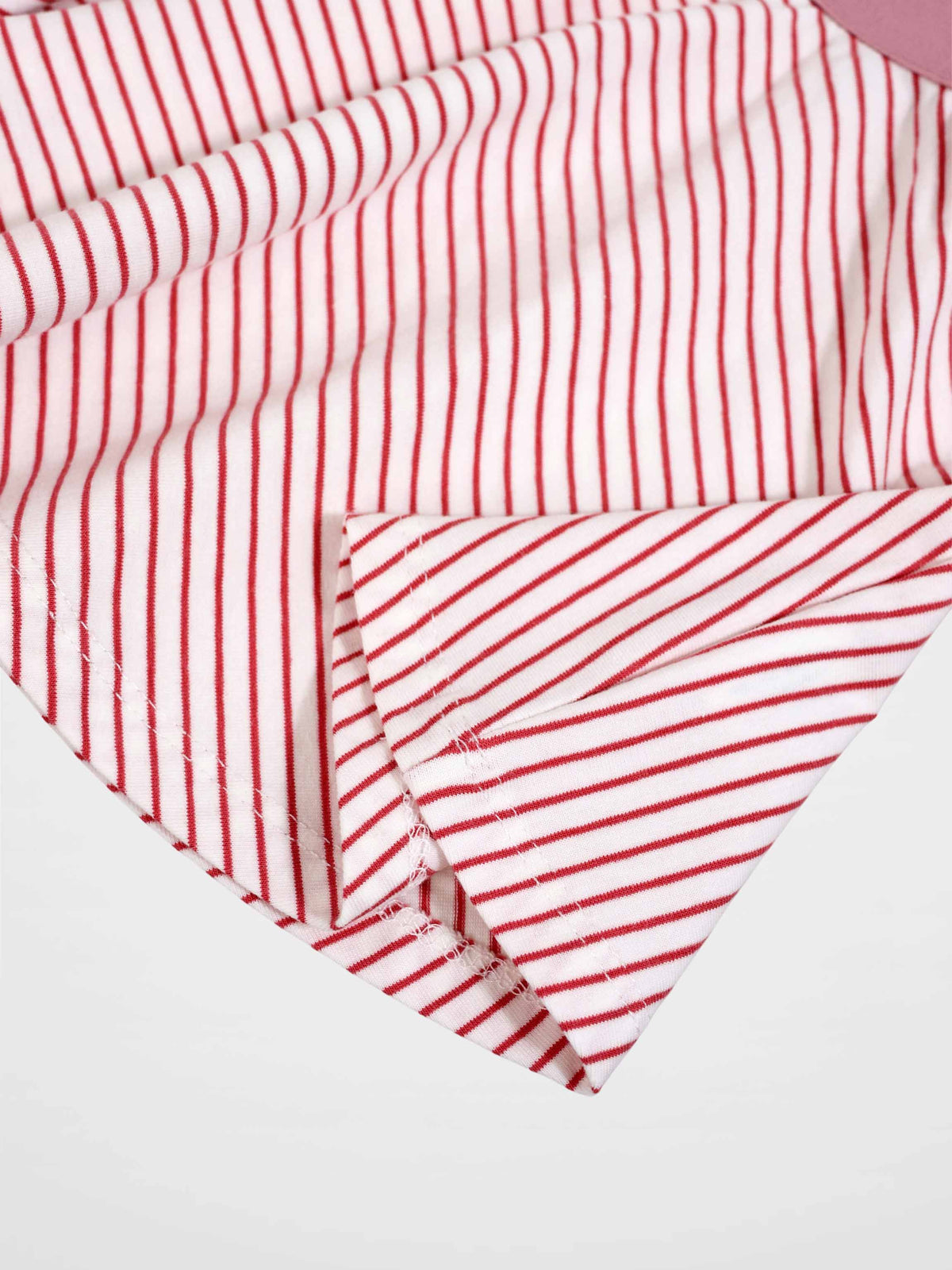 Striped pink girls skirt close-up fabric with red stripes on white background