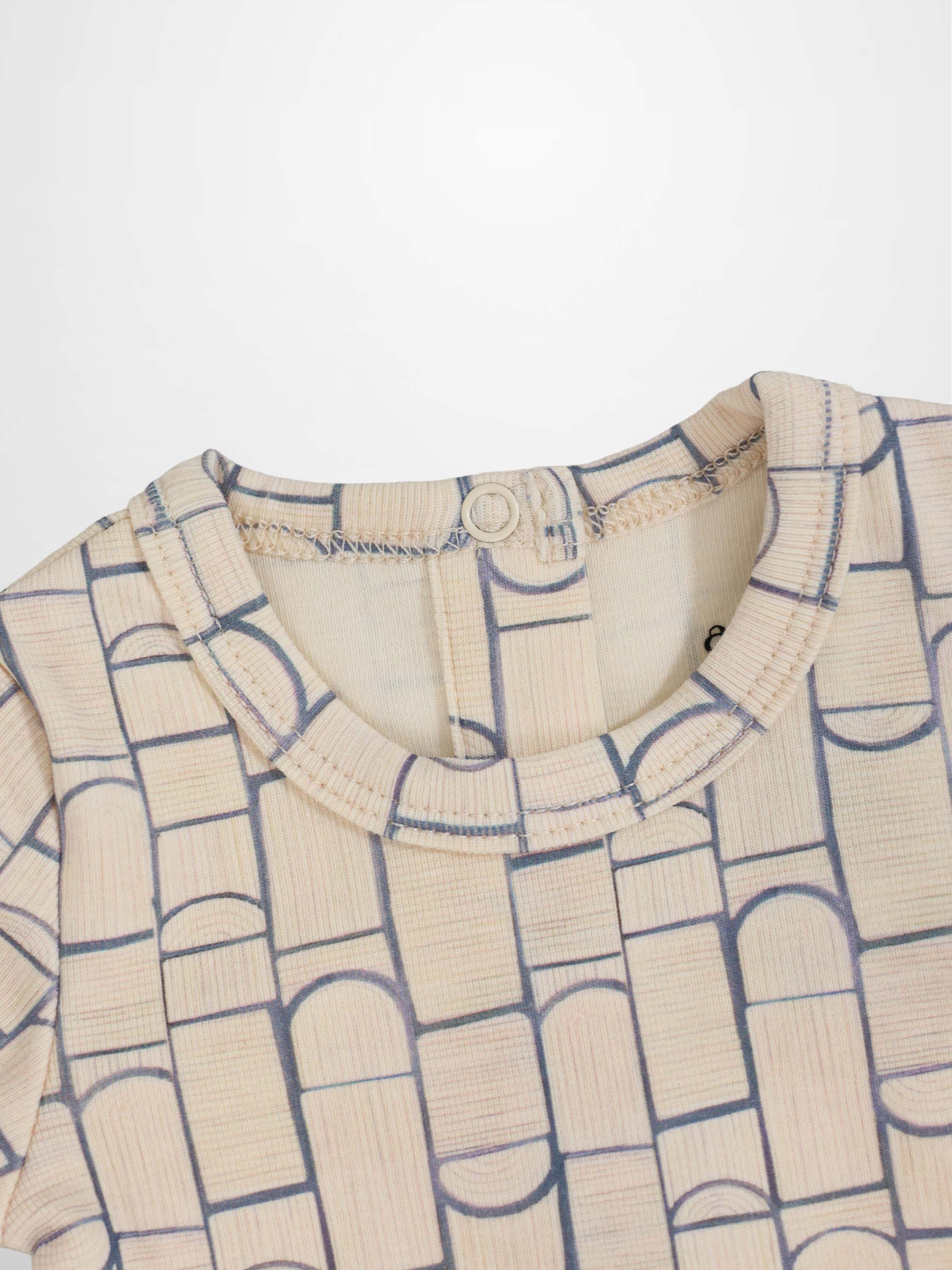 Beige baby jumpsuit with light-blue geometric pattern of rounded rectangles and arches; crossover-front design.