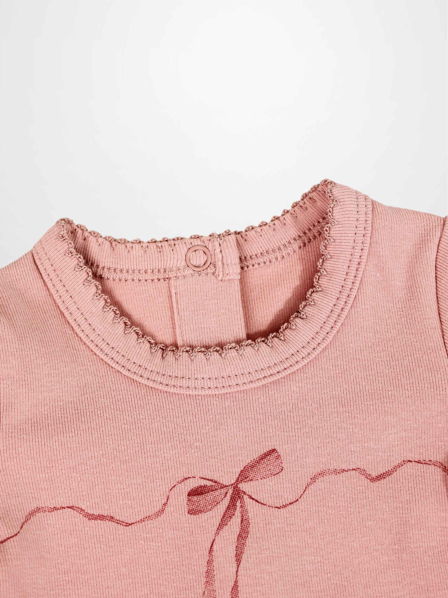 Pink Adee Girls Stretchies top with dark pink wavy ribbon bow and lace trim