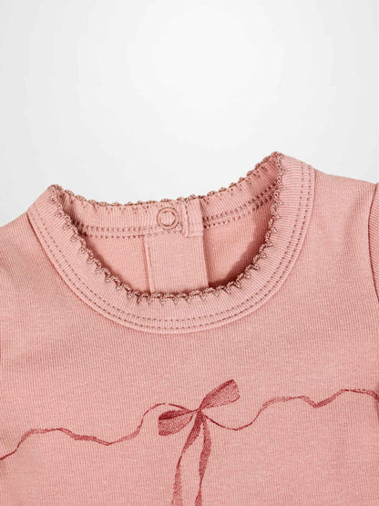 Pink Adee Girls Stretchies top with dark pink wavy ribbon bow and lace trim