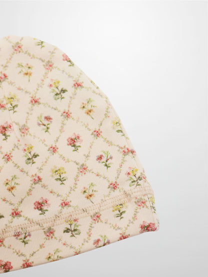 Adee Flower Garden Hat for girls, off-white baby hat with small pink and yellow floral print.