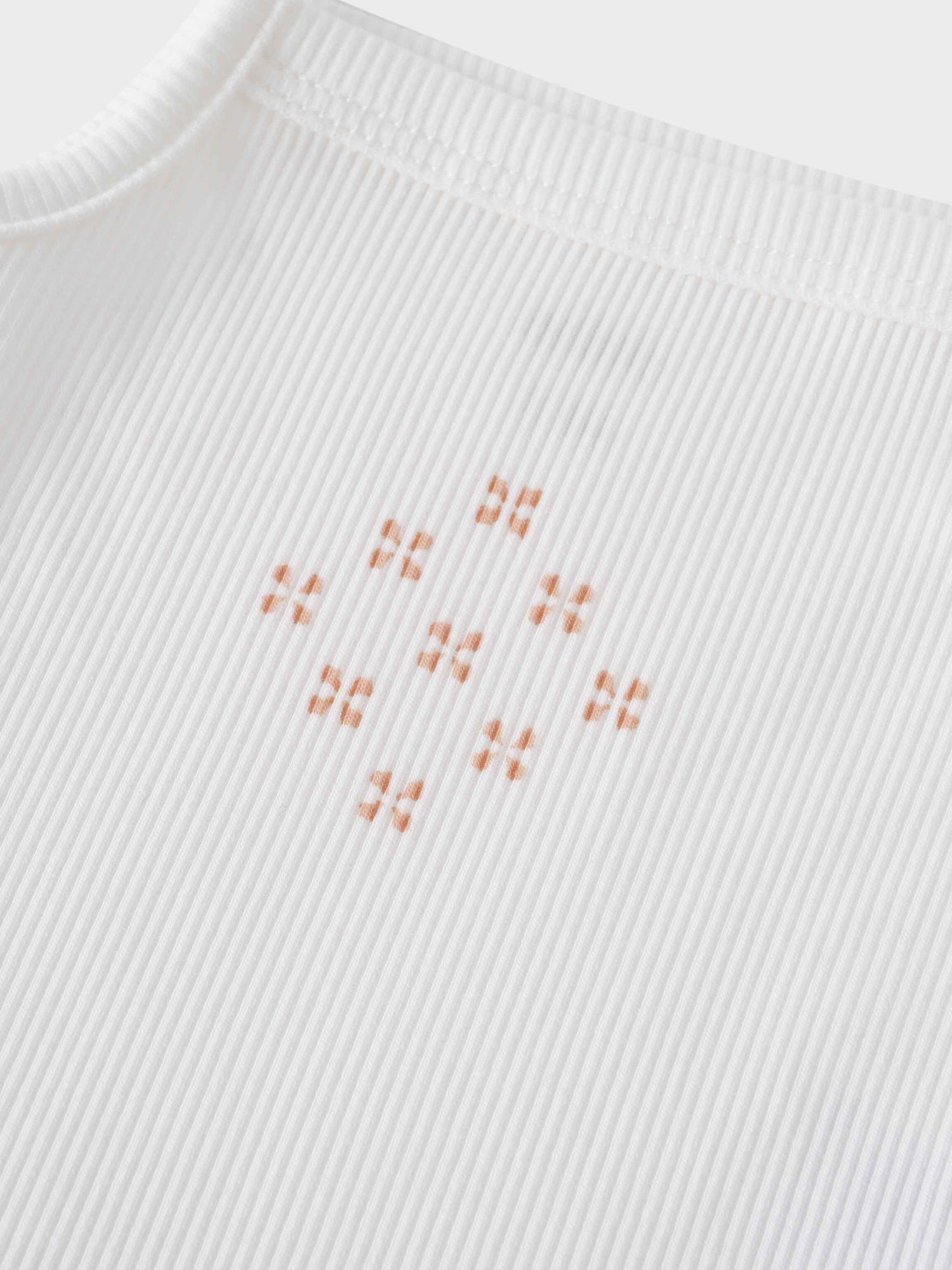 Close-up of diamond pattern on undershirt bodysuit