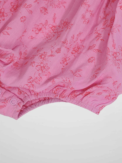 Pink Flower Romper for girls, dressy apparel with pink floral print and elastic leg openings with snap closures.