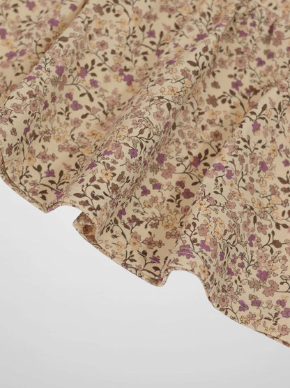 Purple flower skirt featuring beige fabric and tiny purple, pink, and brown floral print.