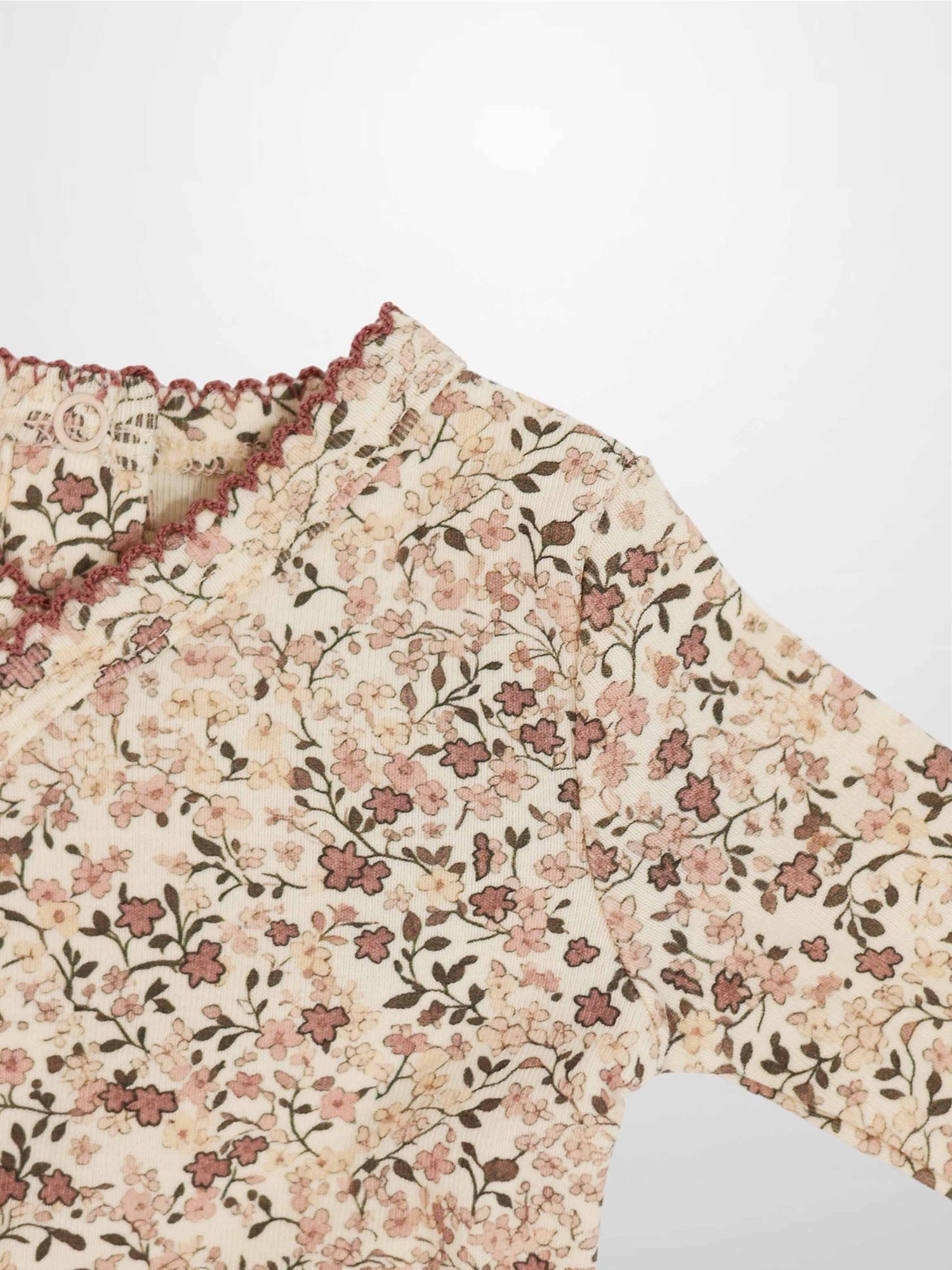 Purple Flower Stretchy by Adee, girls stretchies with all-over pink floral print on cream fabric.