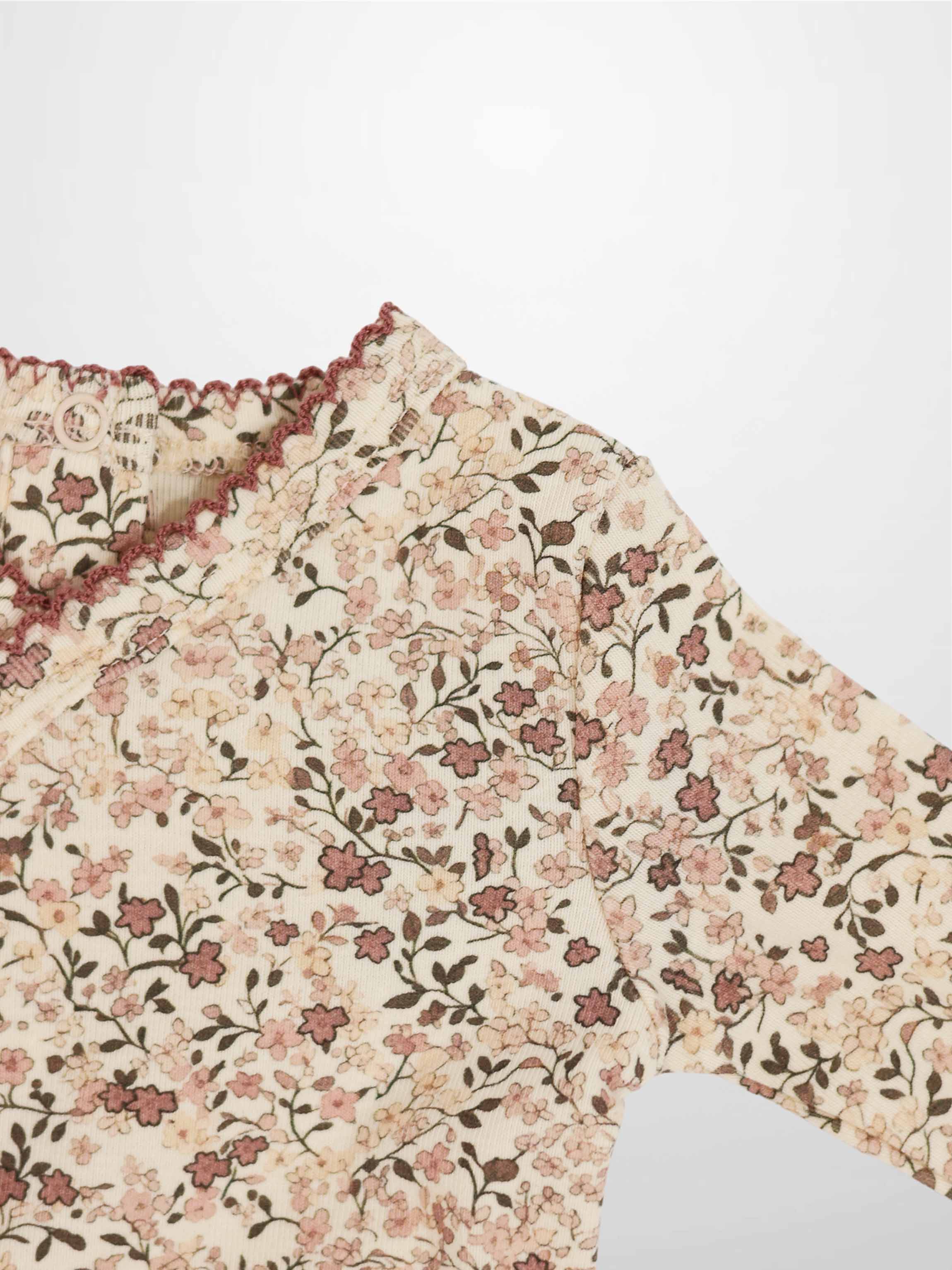 Purple Flower Stretchy by Adee, girls stretchies with all-over pink floral print on cream fabric.