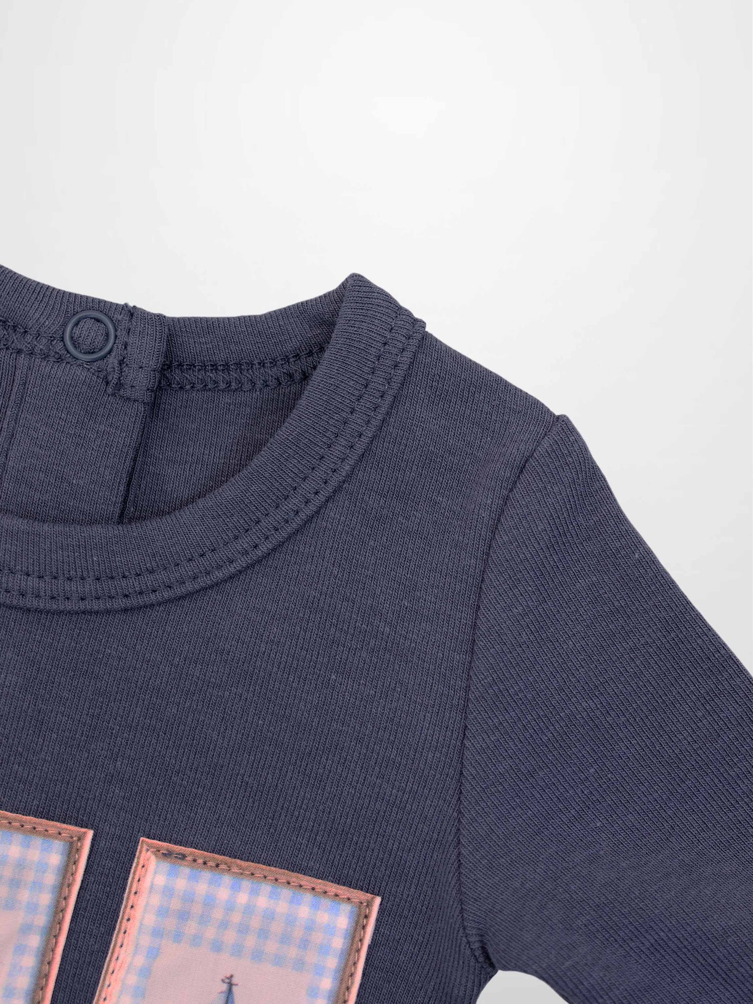 Teddy Frame Stretchy boys’ tee with pink-framed pastel plaid patches on navy fabric