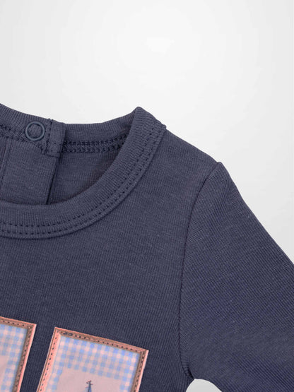 Teddy Frame Stretchy boys’ tee with pink-framed pastel plaid patches on navy fabric
