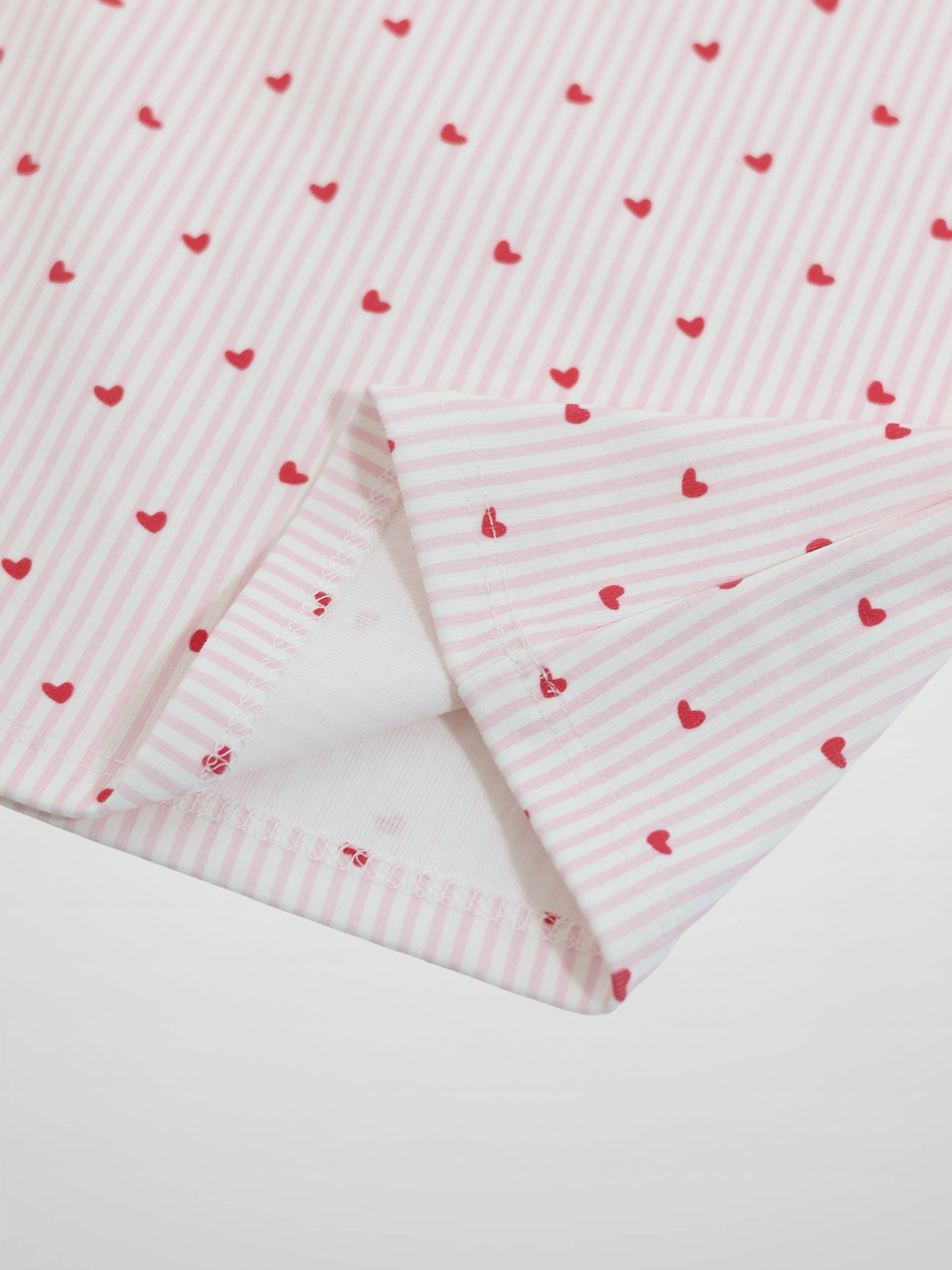 Pink Heart Pajamas for girls; pink-and-white striped fabric with small red hearts.