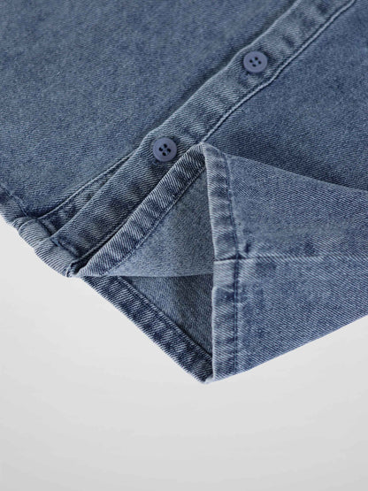 Blue denim romper with button-down front and cuffed sleeve, close-up