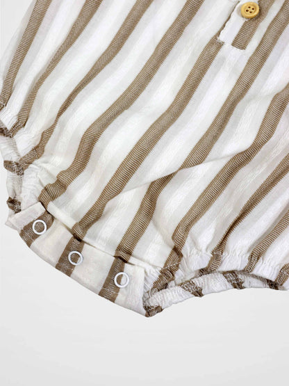 Tan and white striped romper with front button and snap-adjustable leg openings.