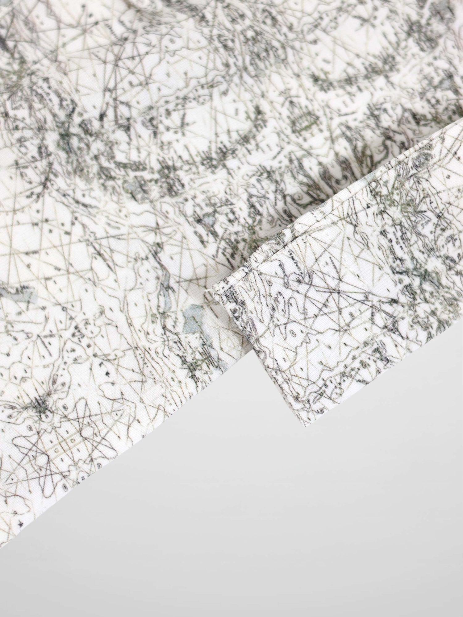Map Stretchy: off-white fabric with sage-green map lines and compass markers.