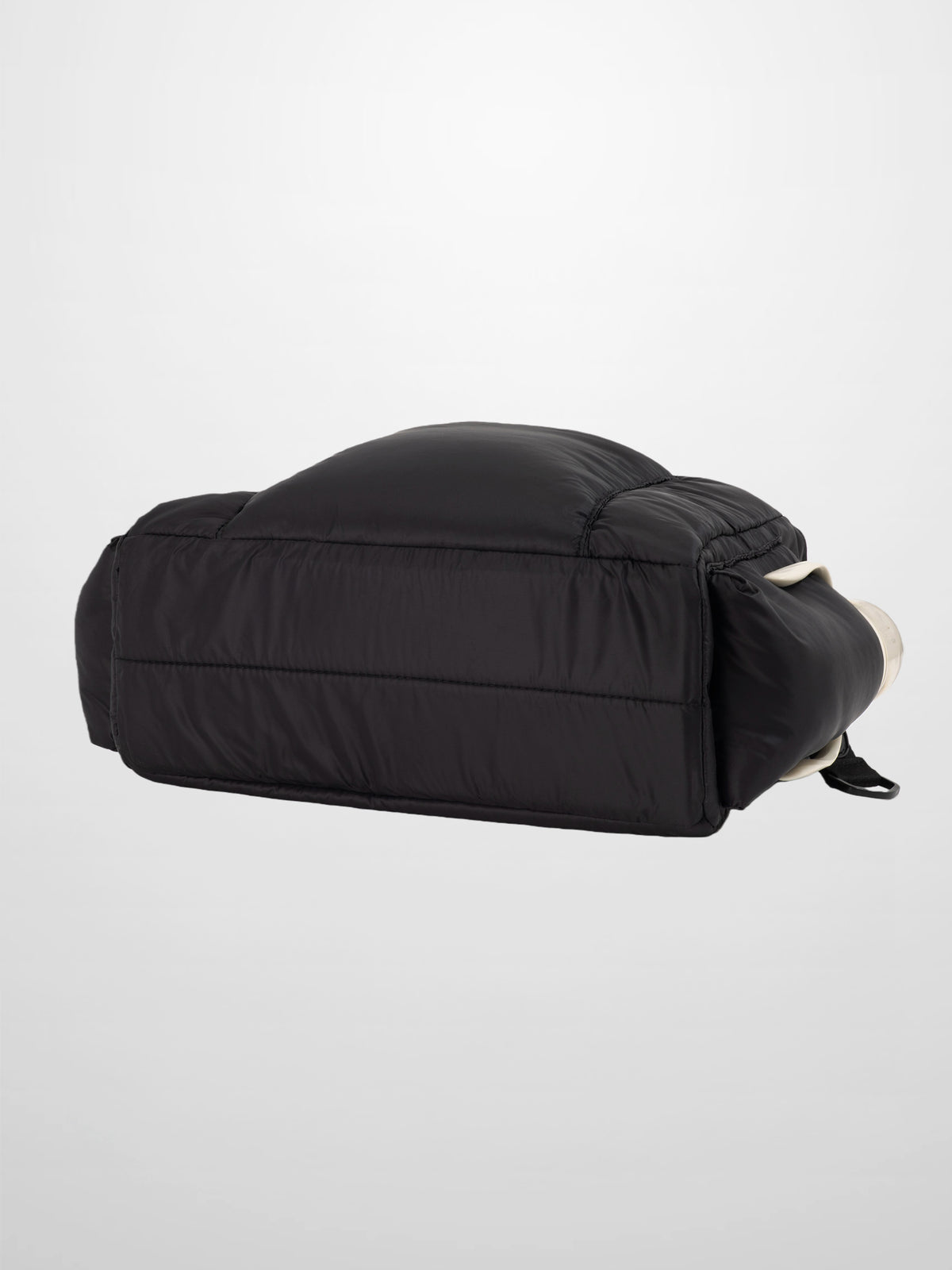 Diaper bag in sleek black padded fabric with foldover design, a modern, practical carry solution.