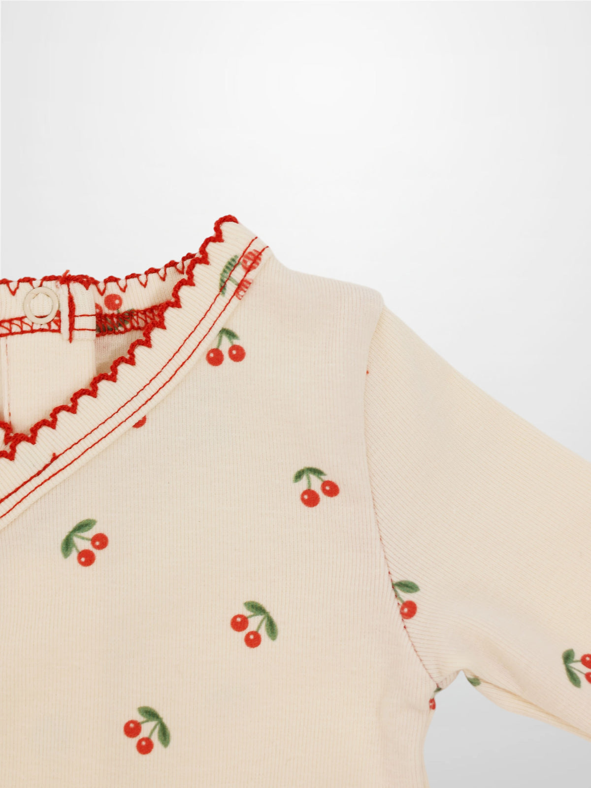 Red Cherry Stretchy girls top by Adee with cherry print on cream knit and green leaves