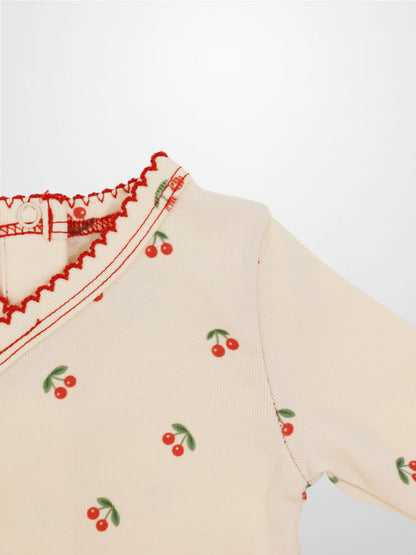 Red Cherry Stretchy girls top by Adee with cherry print on cream knit and green leaves