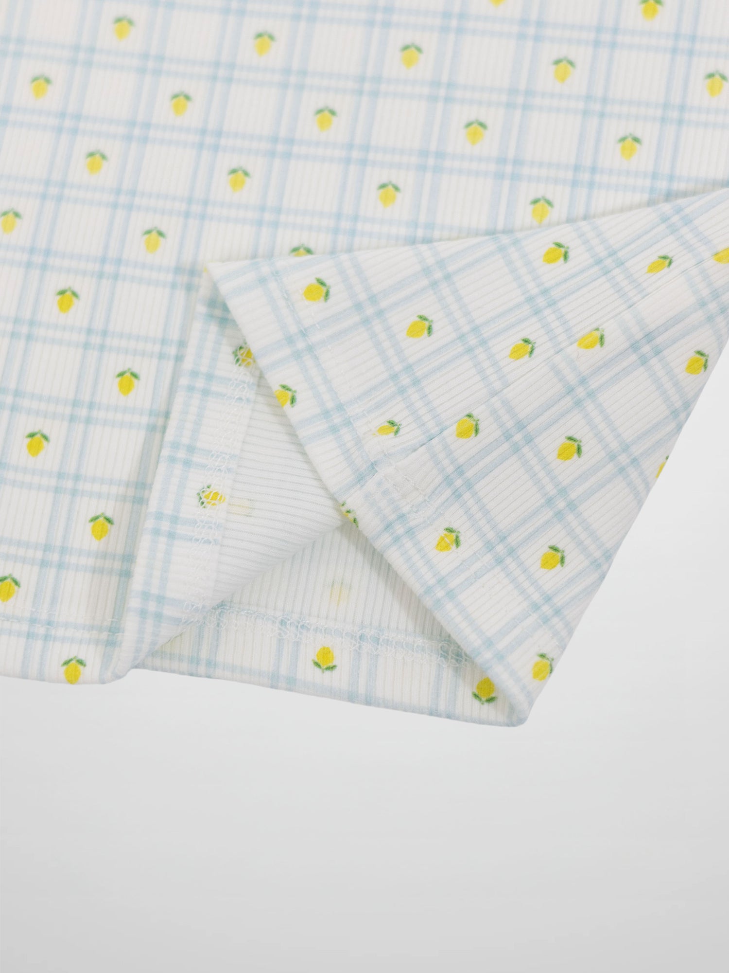 Lemon Window Pajamas fabric close-up: white base with light blue grid plaid and tiny yellow lemons.