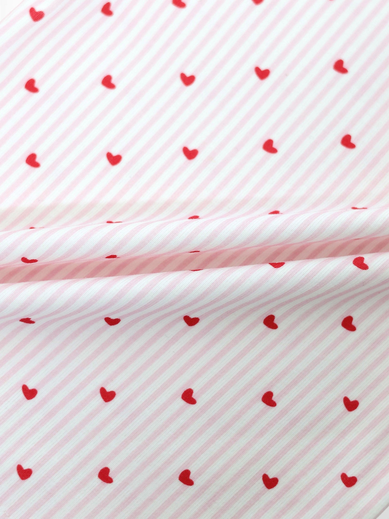 Pink Heart Hat fabric pattern with pink diagonal stripes and red hearts by Adee