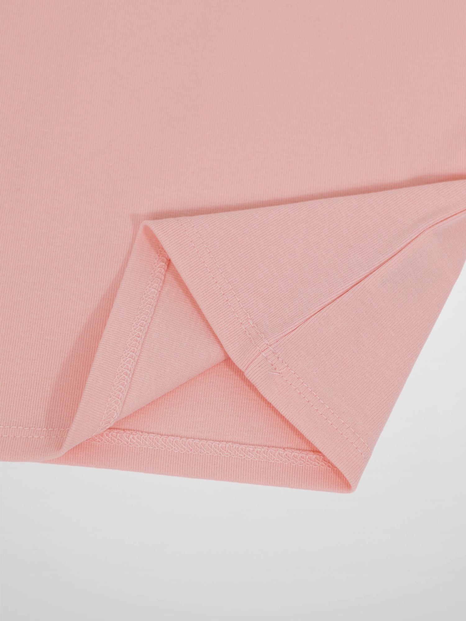 Light pink 3/4 sleeve T-shirt with rolled cuff detail on soft knit fabric.