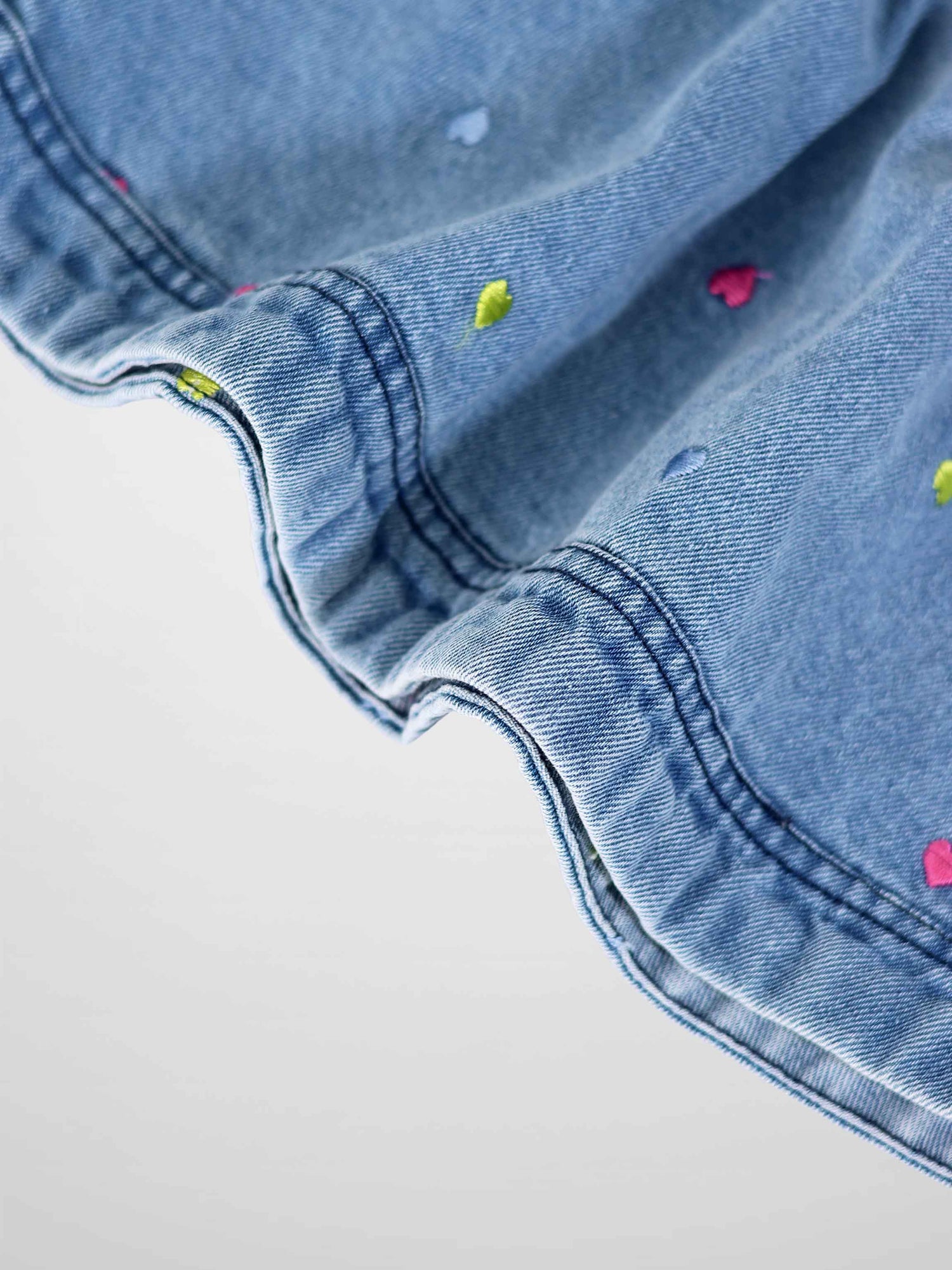 Blue denim fabric with colorful embroidered hearts, Embroidered Heart Denim Skirt.