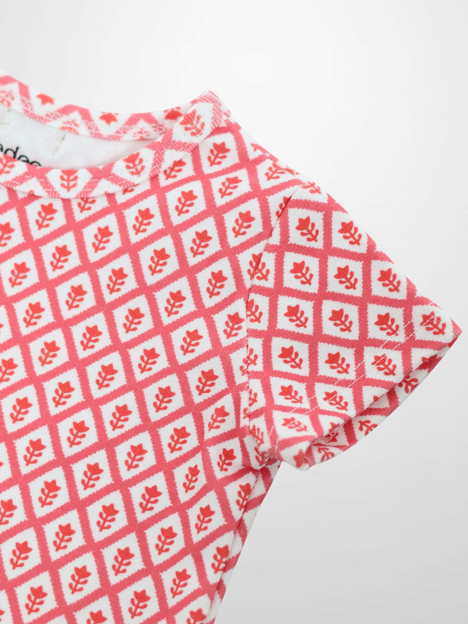 Diamond Flower T-Shirt for girls by Adee, pink diamond lattice pattern with red floral motifs.