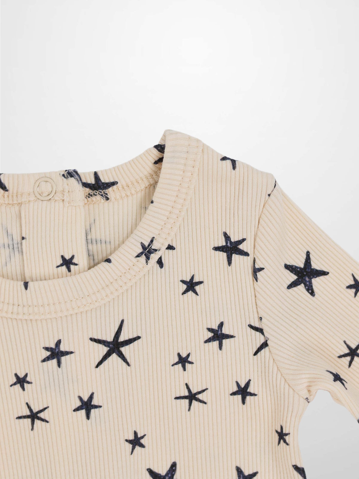 Star Stretchy boys stretchies top in light beige ribbed knit with navy star print by Adee