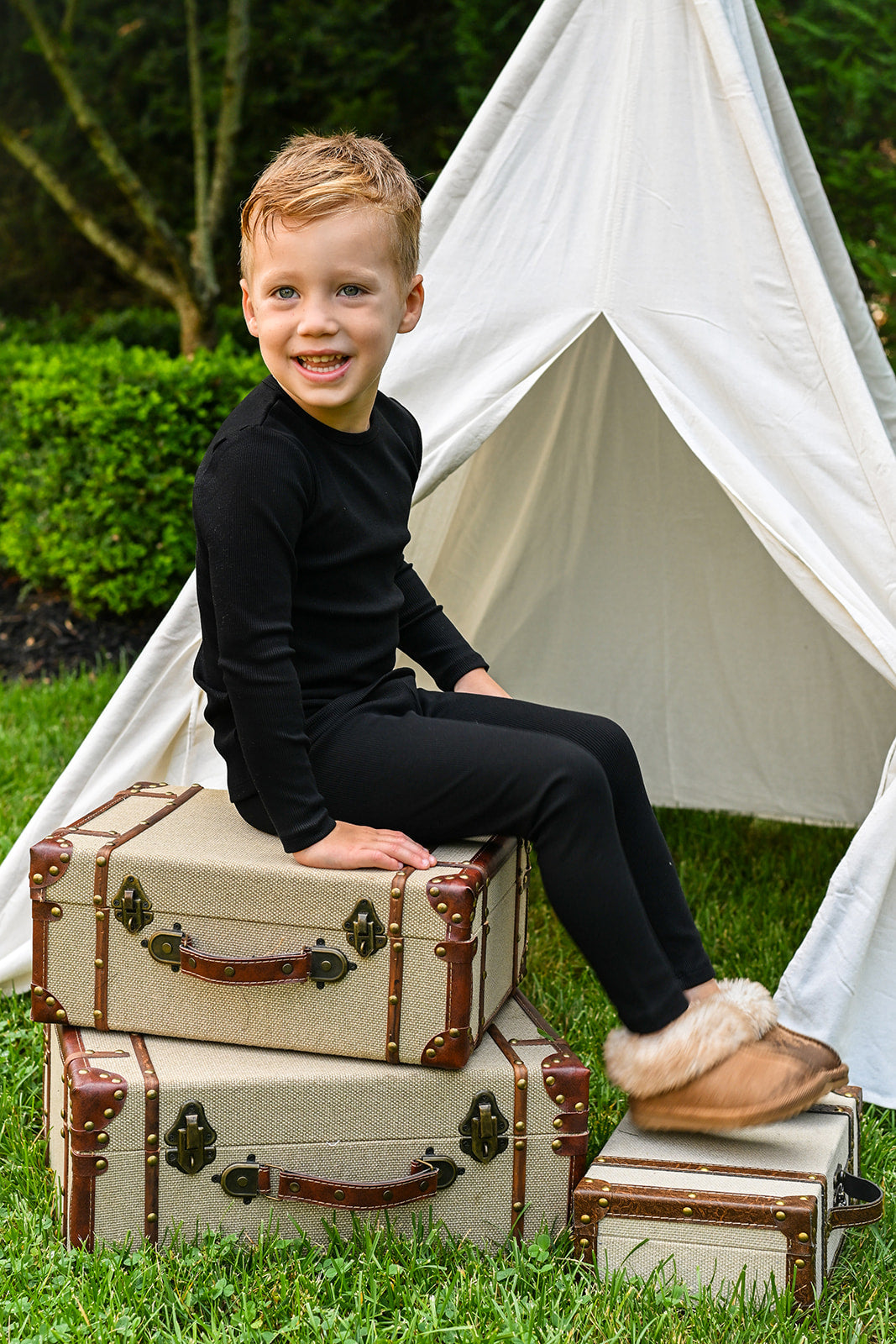 Thin Ribbed Pajama - Black, unisex Adee pajama set worn by a child outdoors.