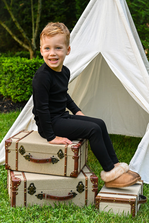Thin Ribbed Pajama - Black, unisex Adee pajama set worn by a child outdoors.
