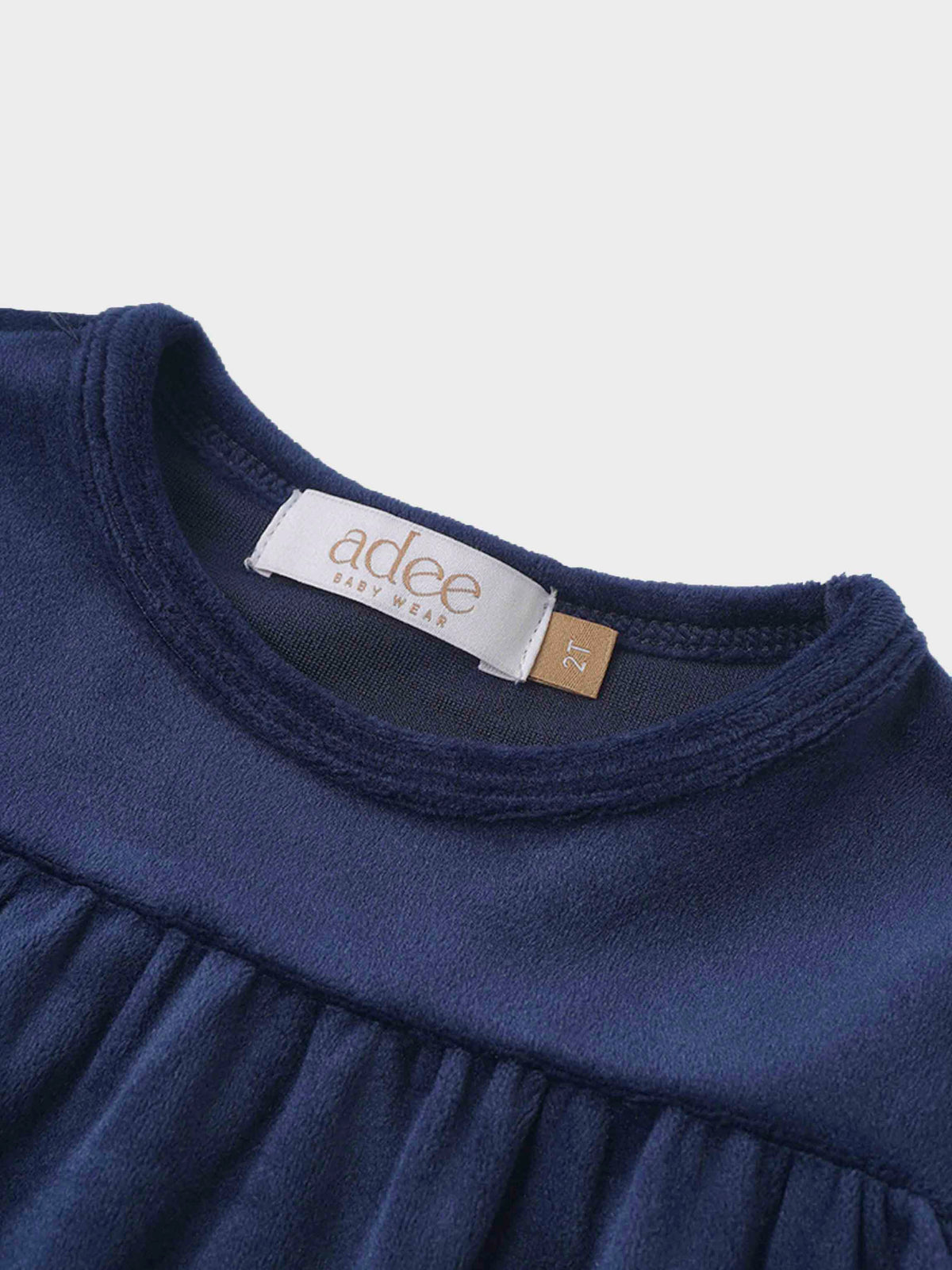 Navy tiered velour robe for toddlers, close-up of neckline and gathered bodice with 2T tag.