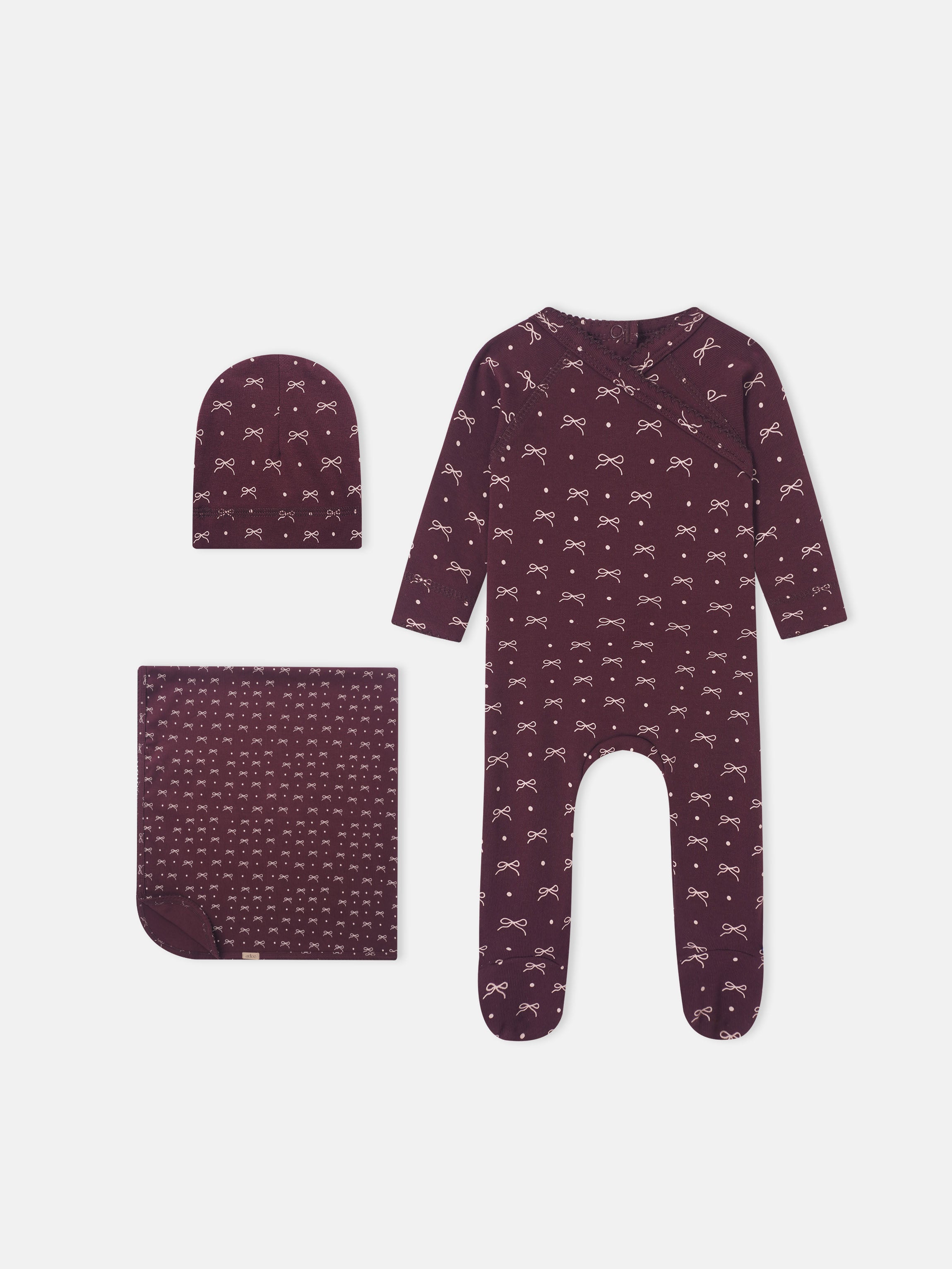 Girls burgundy bow layette set by Adee; includes romper, hat, and blanket with white bow print