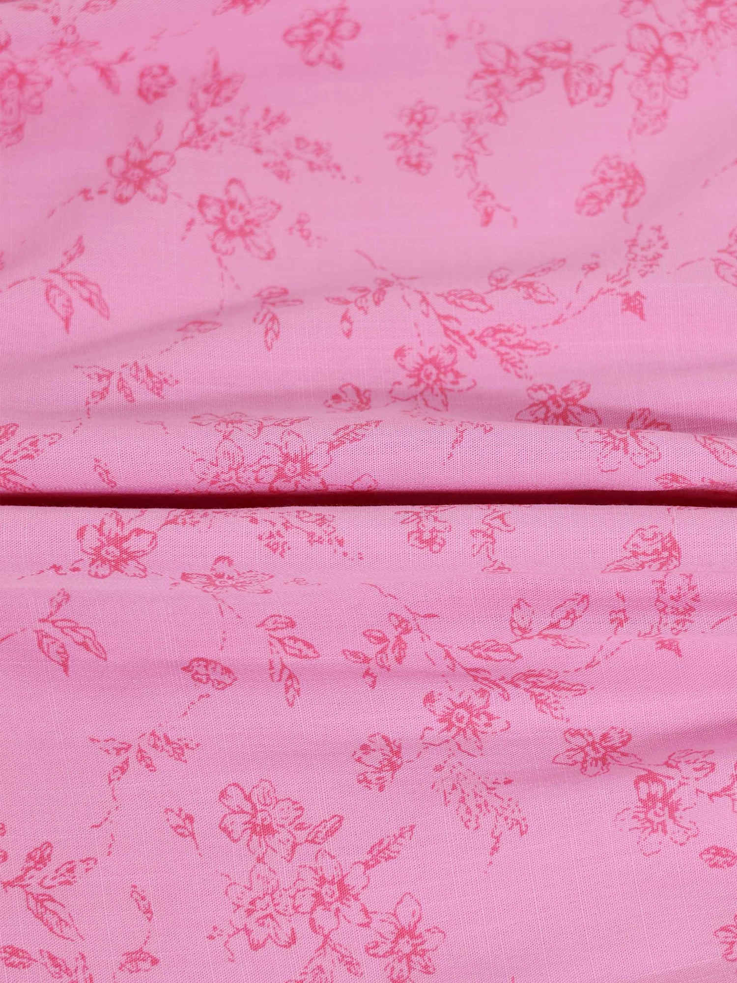 Pink flower print girls dressy romper; fabric close-up shows floral pattern