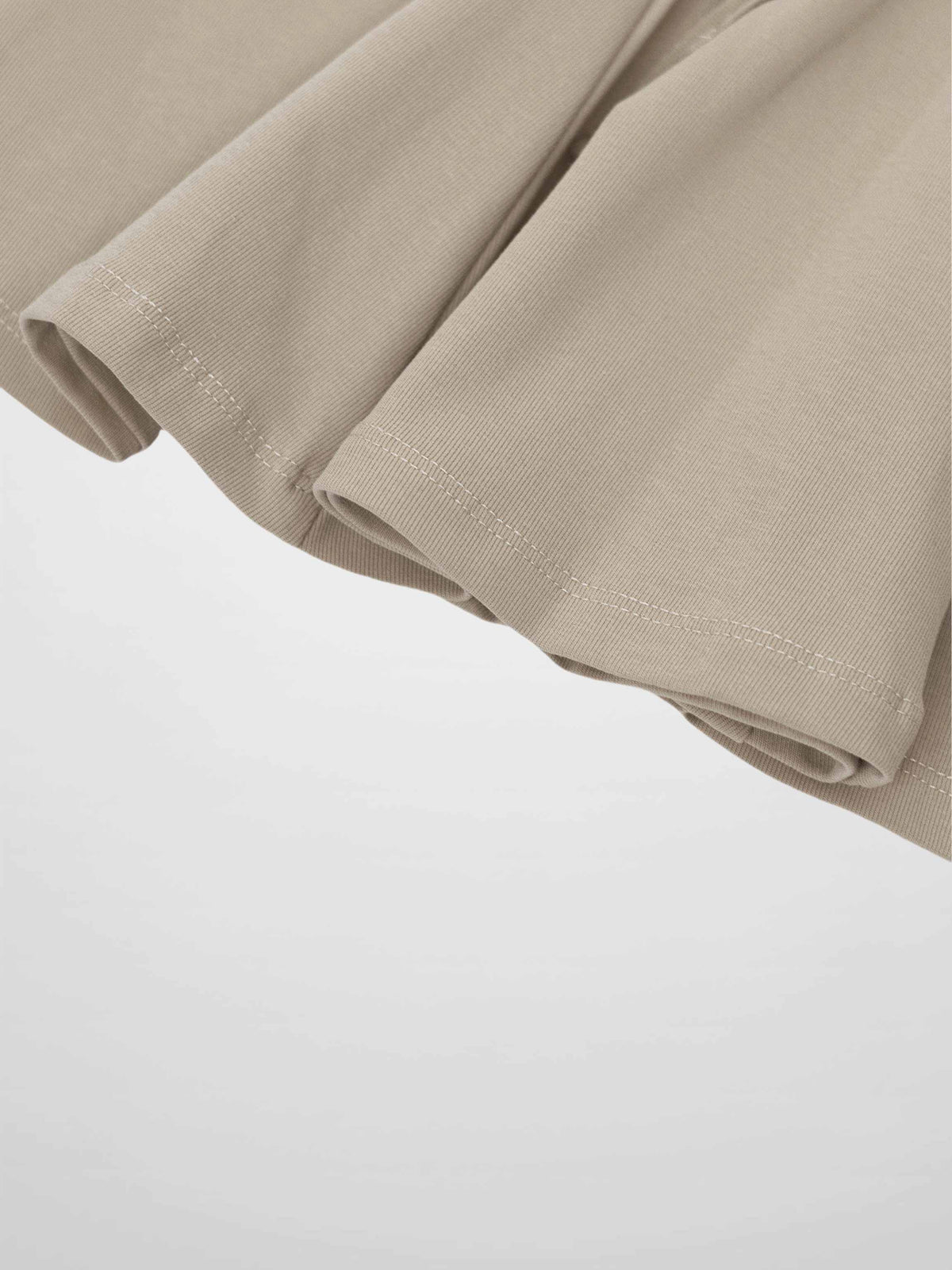 Taupe 6-panel skirt fabric close-up showing hem and stitching.