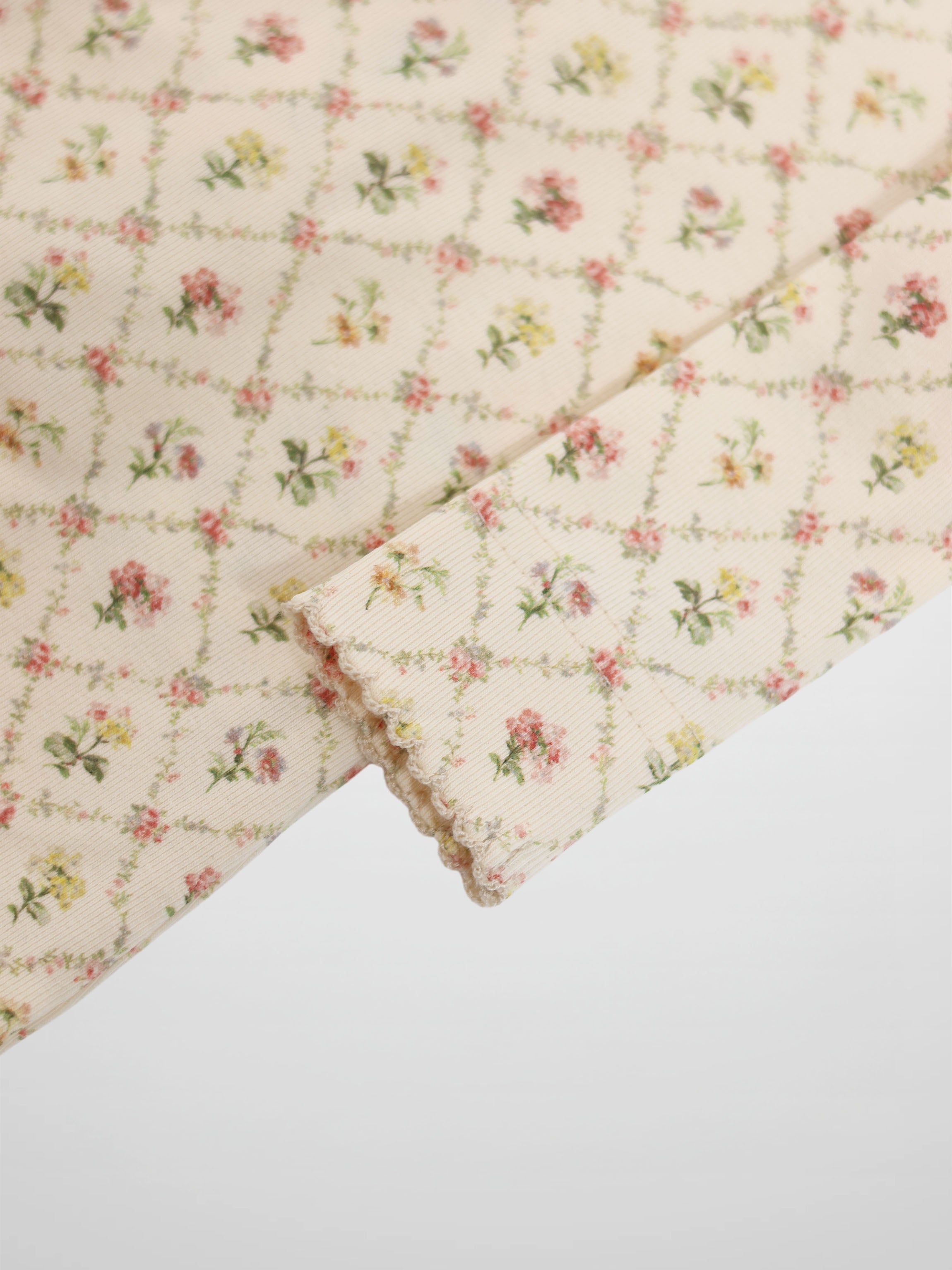 Flower Garden Stretchy girls stretchies in cream with a pink and yellow floral lattice pattern