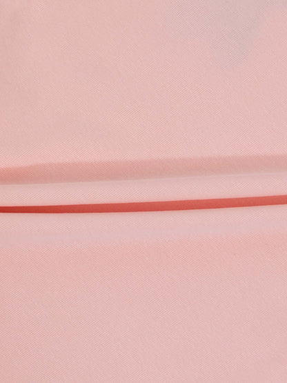 Soft light pink fabric with diagonal weave for a 3/4 sleeve emblem T-shirt.